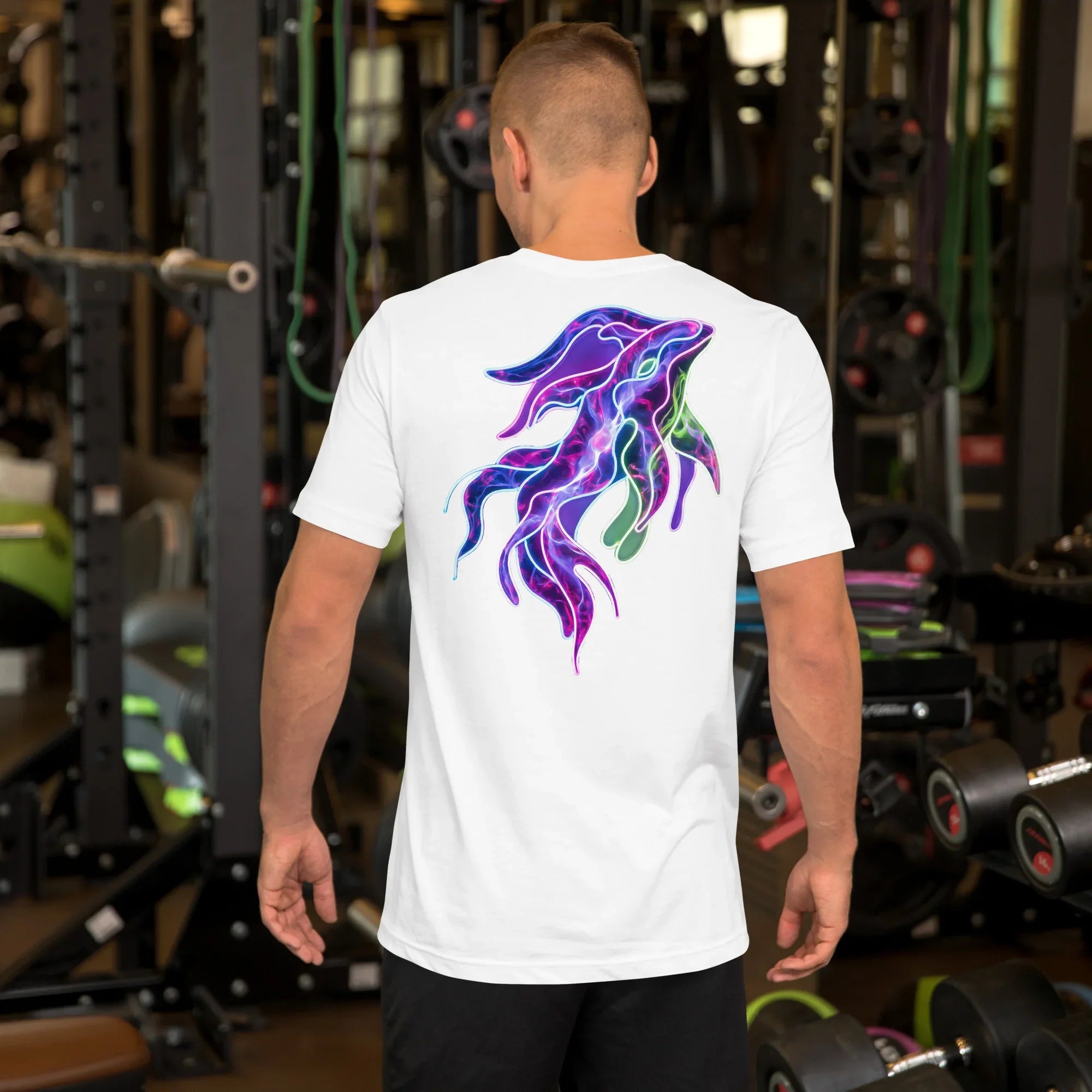 Back view of man wearing white t-shirt with vibrant neon psychedelic squid design in a gym setting