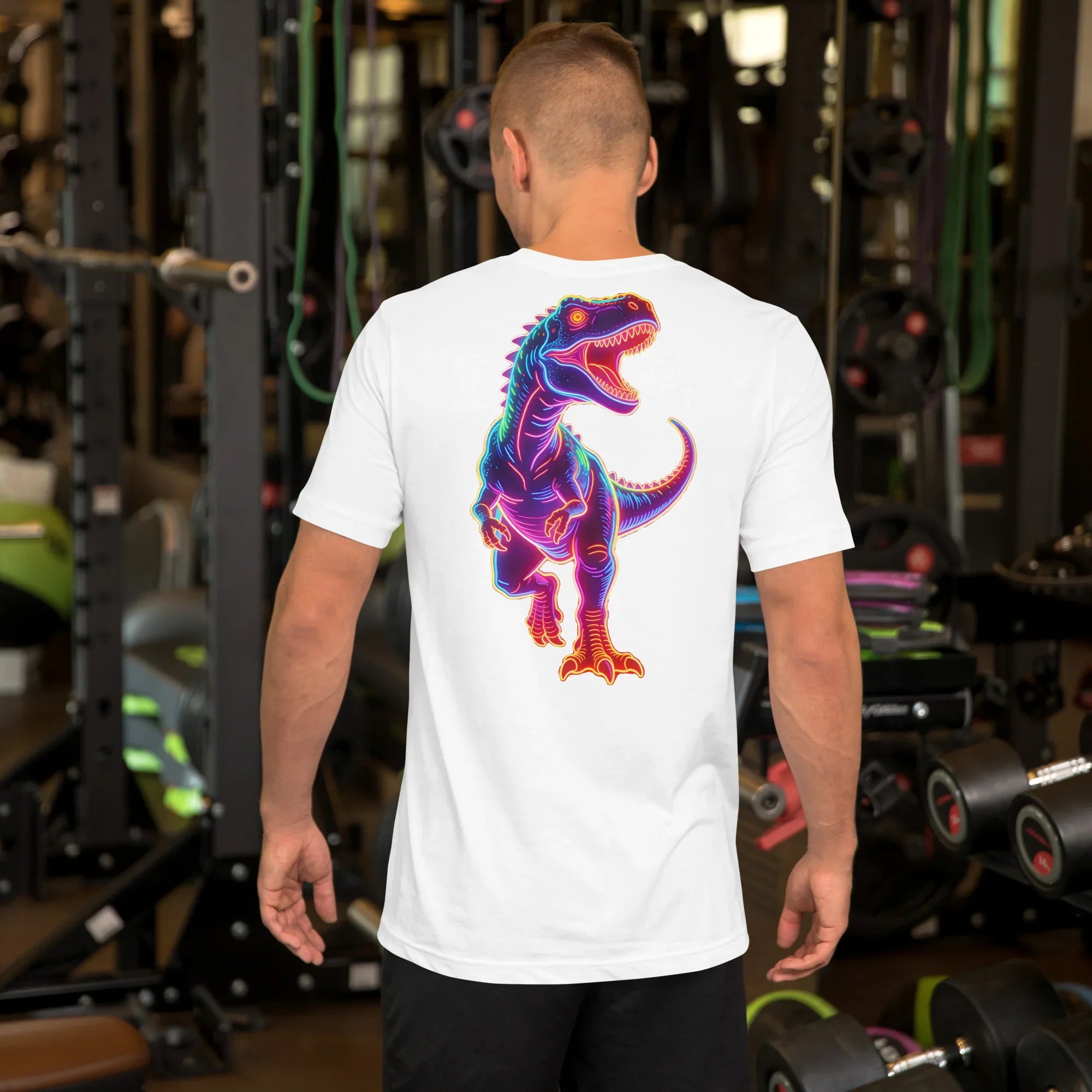 White unisex t-shirt with vibrant neon dinosaur graphic worn by man in gym setting
